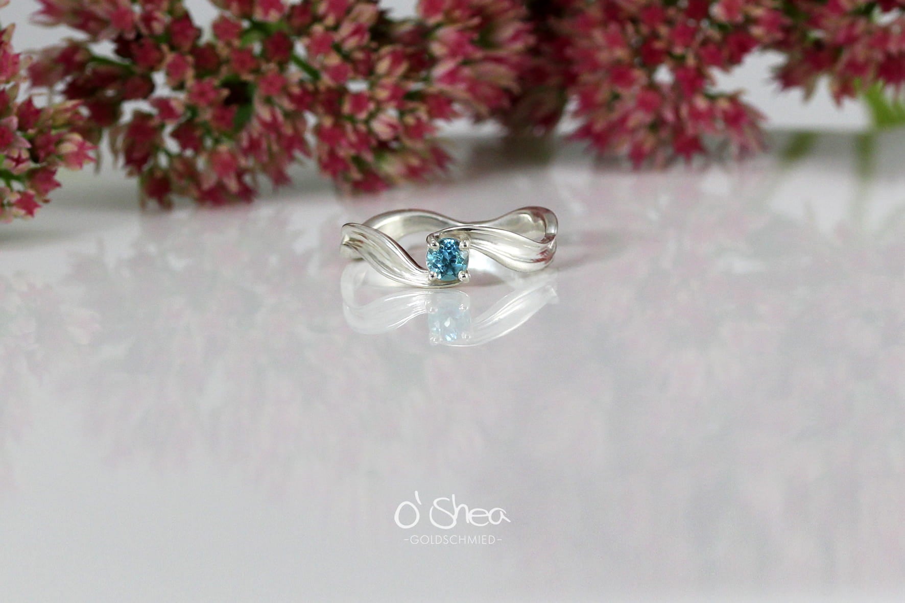 White gold engagement ring with a blue stone. Aquamarine. 